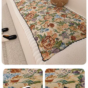 Detailed macro view of vintage floral quilted sofa cover with scalloped edge detail