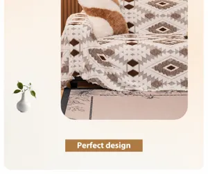 Detail showing the geometric diamond pattern and fringe edge of the plush sofa blanket