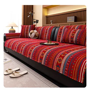 Detail of bohemian red chenille sofa cover with ethnic geometric jacquard patterns