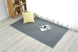 Detail view of grey quilted cotton mat with diamond pattern for home floor decoration