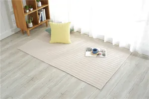 Close-up of cream quilted floor mat with diamond stitching on a light wooden floor