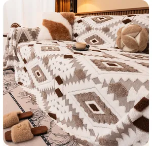 Detail of bohemian geometric knit sofa throw with plush texture and fringe tassels