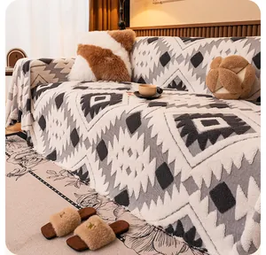 Detail of plush winter sofa blanket featuring ethnic geometric patterns and soft fringes