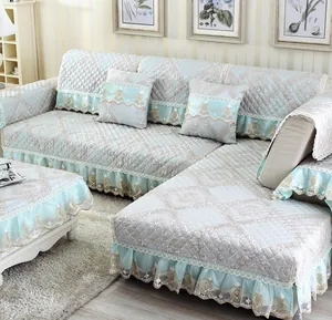 Close-up of light blue quilted plush sofa cover with floral embroidery and lace edges