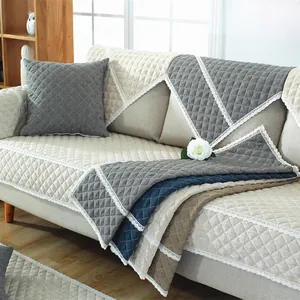 Detail of quilted faux rabbit fur sofa cover with lace edges and diamond texture