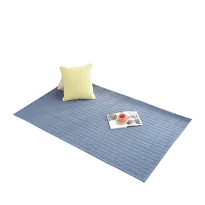 Quilted blue cotton floor mat with diamond leaf pattern and reinforced edges