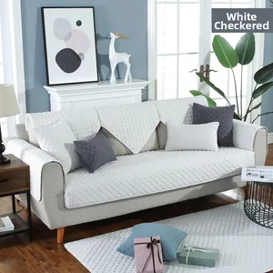 Detailed view of white grid quilted cotton mat on sofa with soft decorative pillows