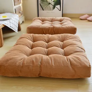 Detail of square caramel corduroy floor cushion with nine-hole button tufted design