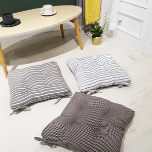 Detail of square quilted seat cushions with linen texture and secure chair ties