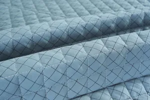 Primer plano del cojín de silla acolchado de algodón azul con diseño de diamantes