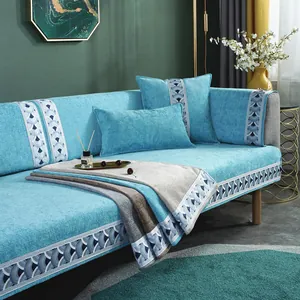 Detail of light blue chenille sofa cover with scallop jacquard trim and matching pillows