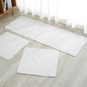 Detail of white quilted cotton seat pads featuring a minimalist diamond stitching pattern