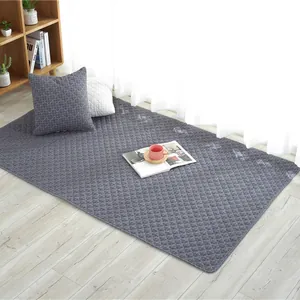 Quilted cotton floor mat for babies with grey diamond pattern on light wooden floor