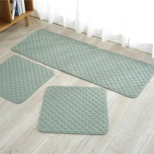 Detail of grey-green quilted chair cushions with diamond patterns and rounded edges