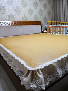 Detailed close-up of woven Indonesian rattan cooling mat with white lace embroidery edges