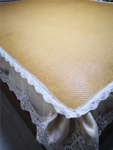 Close-up of woven summer cooling mat with elegant white lace embroidery skirt