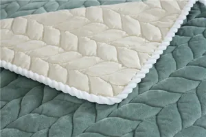 Detailed close-up of leaf-shaped quilted velvet fabric with decorative white rope edges