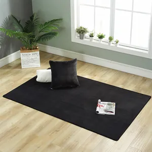 Detailed view of luxury black plush rug on wood floor with minimalist home decor