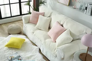 Detailed view of plush faux rabbit fur sofa cushions and colorful pillows in home setting