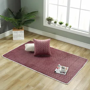 Detail of plush dusty pink quilted rug with leaf texture and matching home accessories