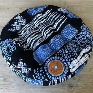 Close-up of a round cotton linen floor cushion with ethnic patterns on wood floor