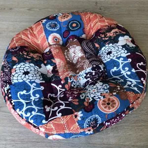 Top view of round Japanese style floor cushion with bohemian mandala floral pattern and tufts
