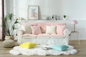 Detailed view of plush velvet sofa cushions and colorful accent pillows in a cozy interior