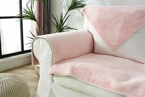 Detailed view of pink plush sofa cover with soft faux fur texture and neat edge binding