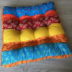 Detail of bohemian patchwork seat cushion with floral patterns and quilted texture