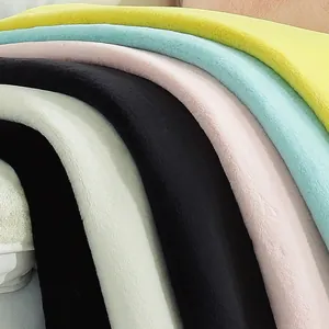 Thick faux rabbit fur rug in yellow, blue, pink, and white for soft bedroom flooring