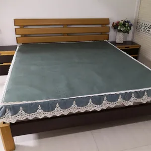 Close-up of gray-green rattan cooling mattress with delicate white lace edge detailing
