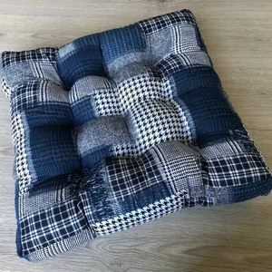 Close-up of quilted cotton linen floor cushion with dark blue patchwork checkered patterns