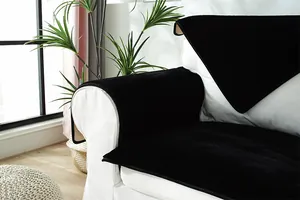 Close-up of plush black sofa cover set on white couch featuring non-slip back texture