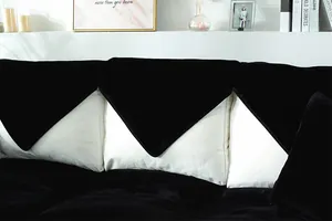 Detail of premium black velvet sofa cover with smooth texture and luxury stitching finish