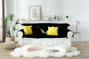 Detail of plush black faux rabbit fur sofa cover set with colorful matching pillows