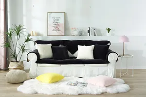 Close-up of thick plush faux rabbit fur sofa cover with black and white shaggy cushions