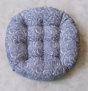 Macro detail of round thick cotton linen cushion with blue Japanese wave pattern