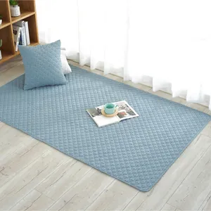 Quilted blue cotton floor mat with diamond pattern and matching pillow for babies