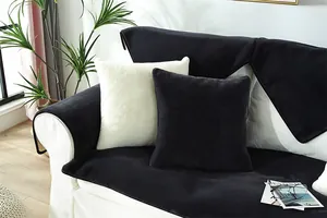 Close-up of thick plush faux rabbit fur sofa cover and cushions in black and white