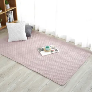 Pink quilted cotton floor mat with a classic square pattern for home nursery and kids
