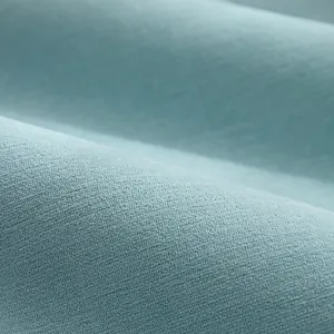 Vista macro della texture del tessuto in ciniglia ad alta densità in blu ciano