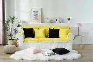 Detailed view of yellow faux rabbit fur sofa cover with matching pillows in a cozy room