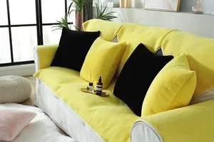 Close-up of thick yellow rabbit plush sofa cover with detailed white edge stitching