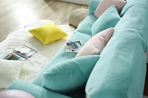Close-up of mint green faux rabbit fur sofa cover with thick soft plush texture