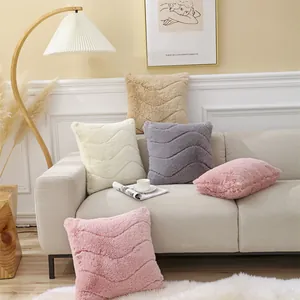 Close-up of plush faux rabbit fur pillows with wavy quilting in soft Morandi colors