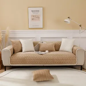 Detailed view of camel quilted velvet sofa cover with textured leaf patterns and white piping