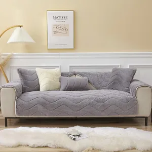 Detail of plush grey sofa cushion with wavy stitching and thick faux fur texture