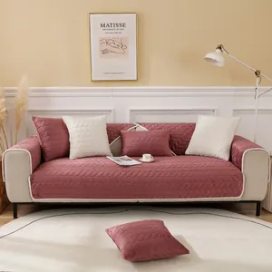 Detail of dark pink velvet quilted sofa cover with leaf pattern and twisted rope edge