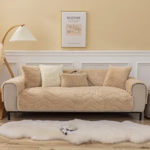 Close-up of camel plush sofa cushion with textured wave pattern and matching pillows