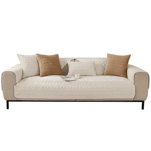 Quilted cream white sofa cover set with leaf pattern and decorative fringe details